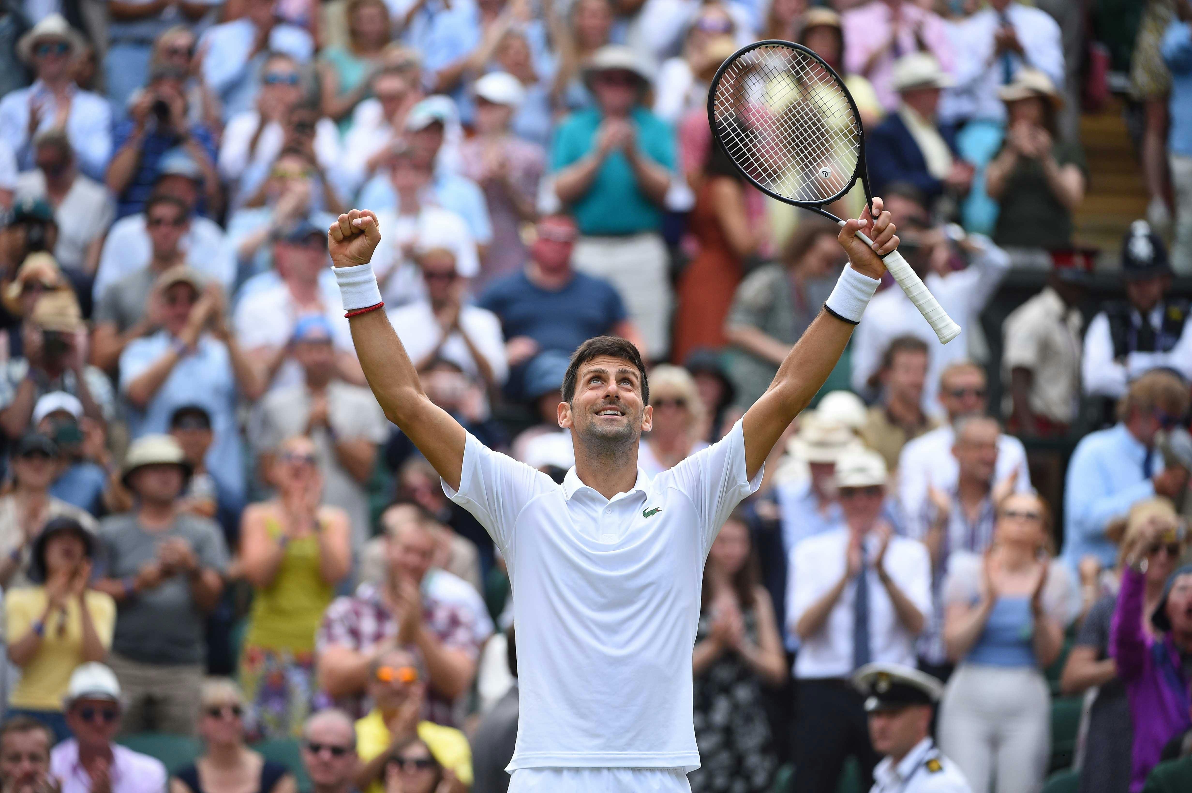 Novak Djokovic smiling after his quarter final win at Wimbledon 2019