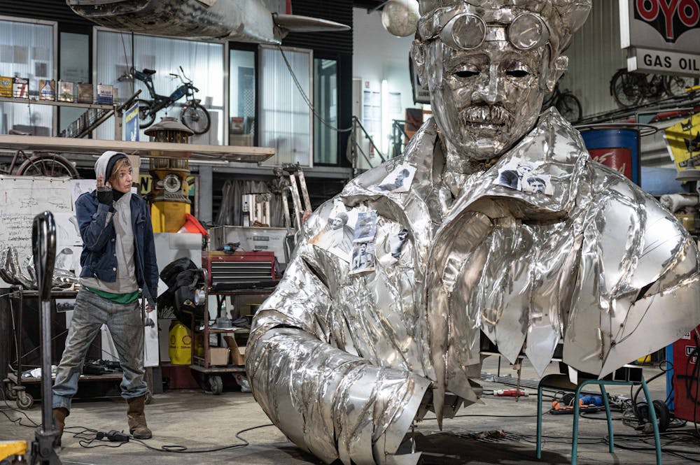 Caroline Brisset in her studio in Marseille in front of her monumental sculpture of the aviator Roland Garros