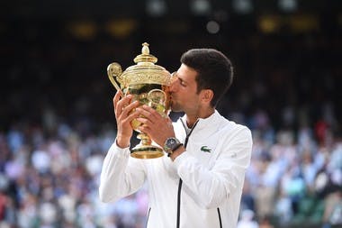Novak Djokovic posing with his trophy at Wimbledon 2019