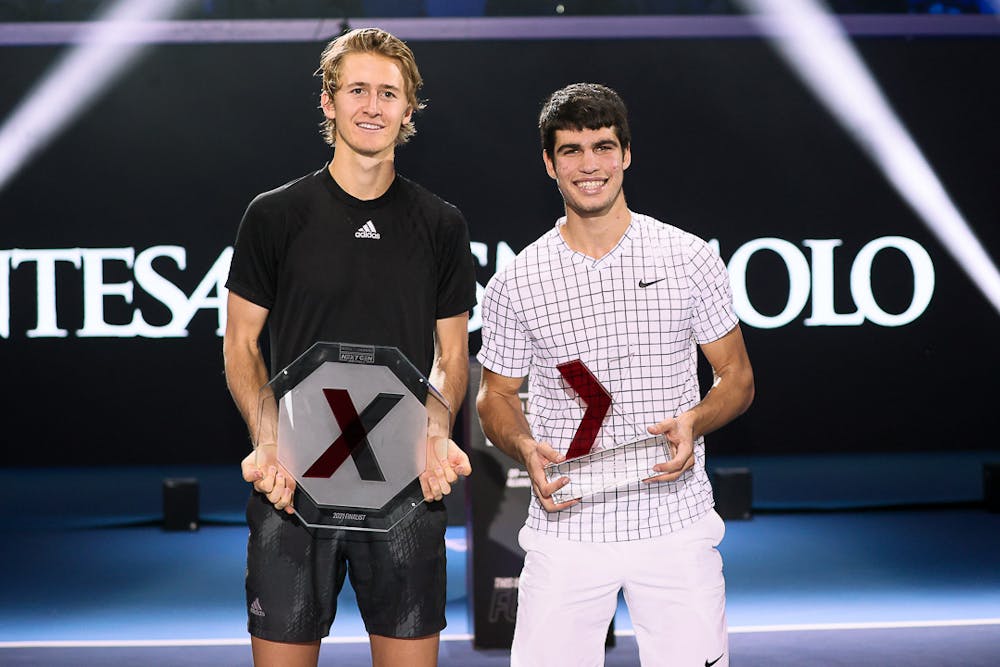 Sebastian Korda and Carlos Alcaraz posing with their 2021 NextGen ATP Finals trophies