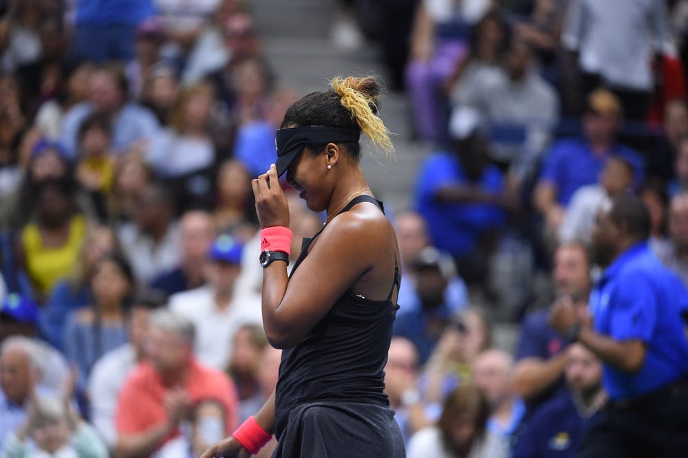 Naomi Osaka hiding behind her cap US Open 2018
