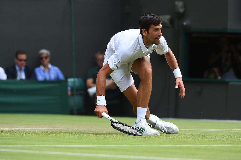Novak Djokovic almost dancing and sliding on the grass at Wimbledon 2019