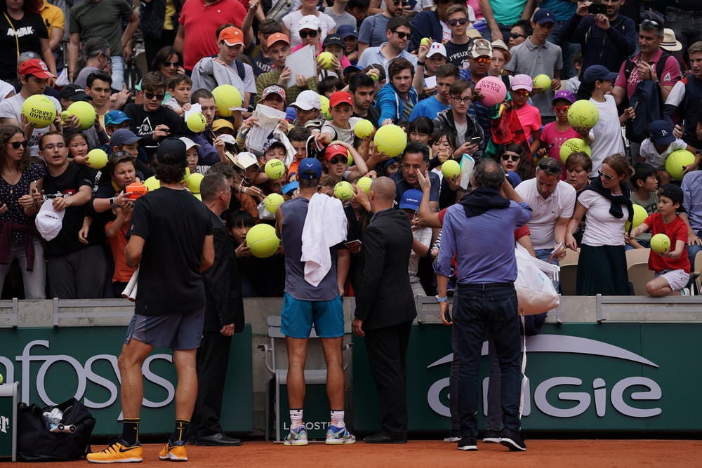 Rafael Nadal signs autographs on Kids Day.