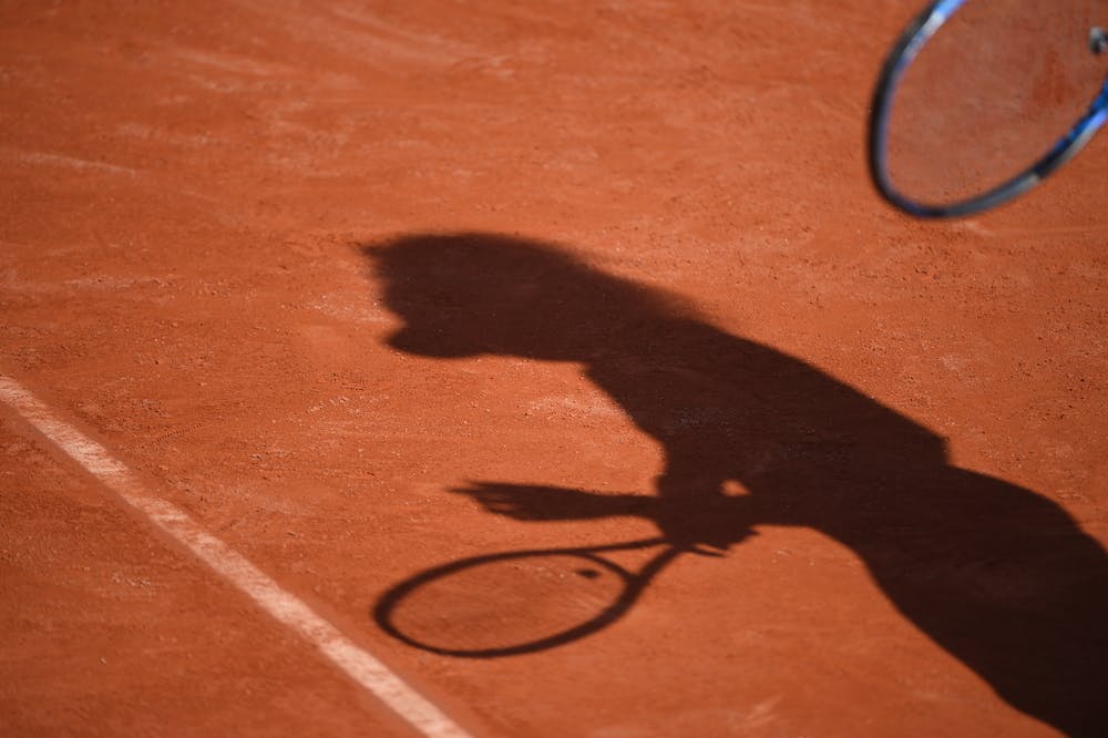 Player's shadow on the clay of Roland-Garros 2019