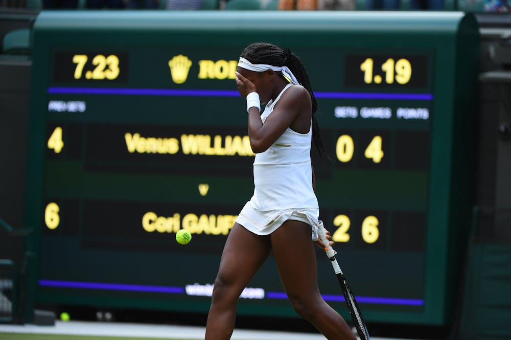 Cori Gauff crying in front of the score board after defeating Venus Williams at Wimbledon 2019
