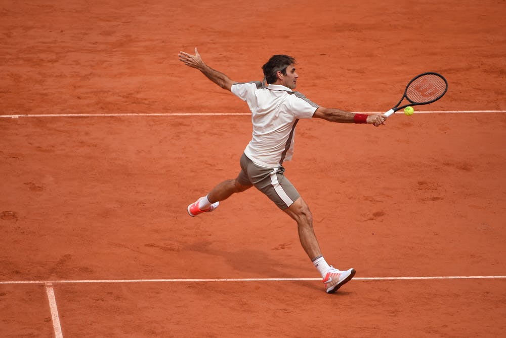Roger Federer hitting a volley at Roland-Garros 2019