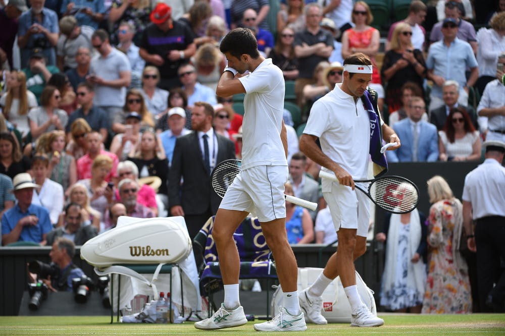 Novak Djokovic and Roger Federer changing ends during the Wimbledon 2019 final