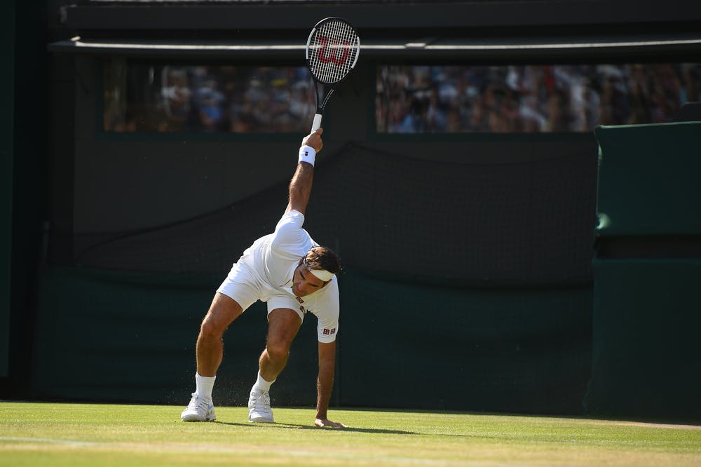 Roger Federer sliding on the grass of Wimbledon 2018