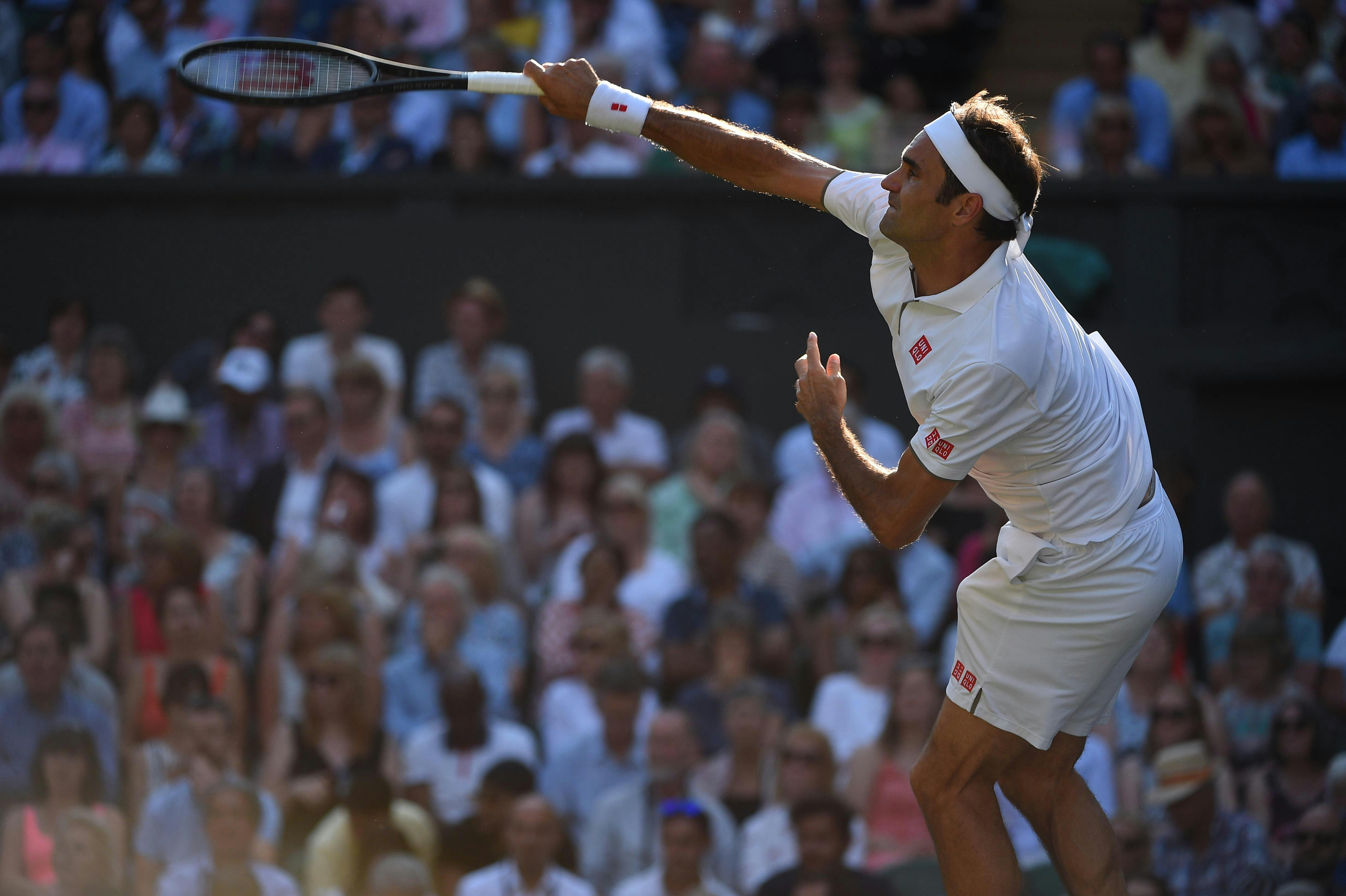 Roger Federer serving during his semi final at Wimbledon 2019
