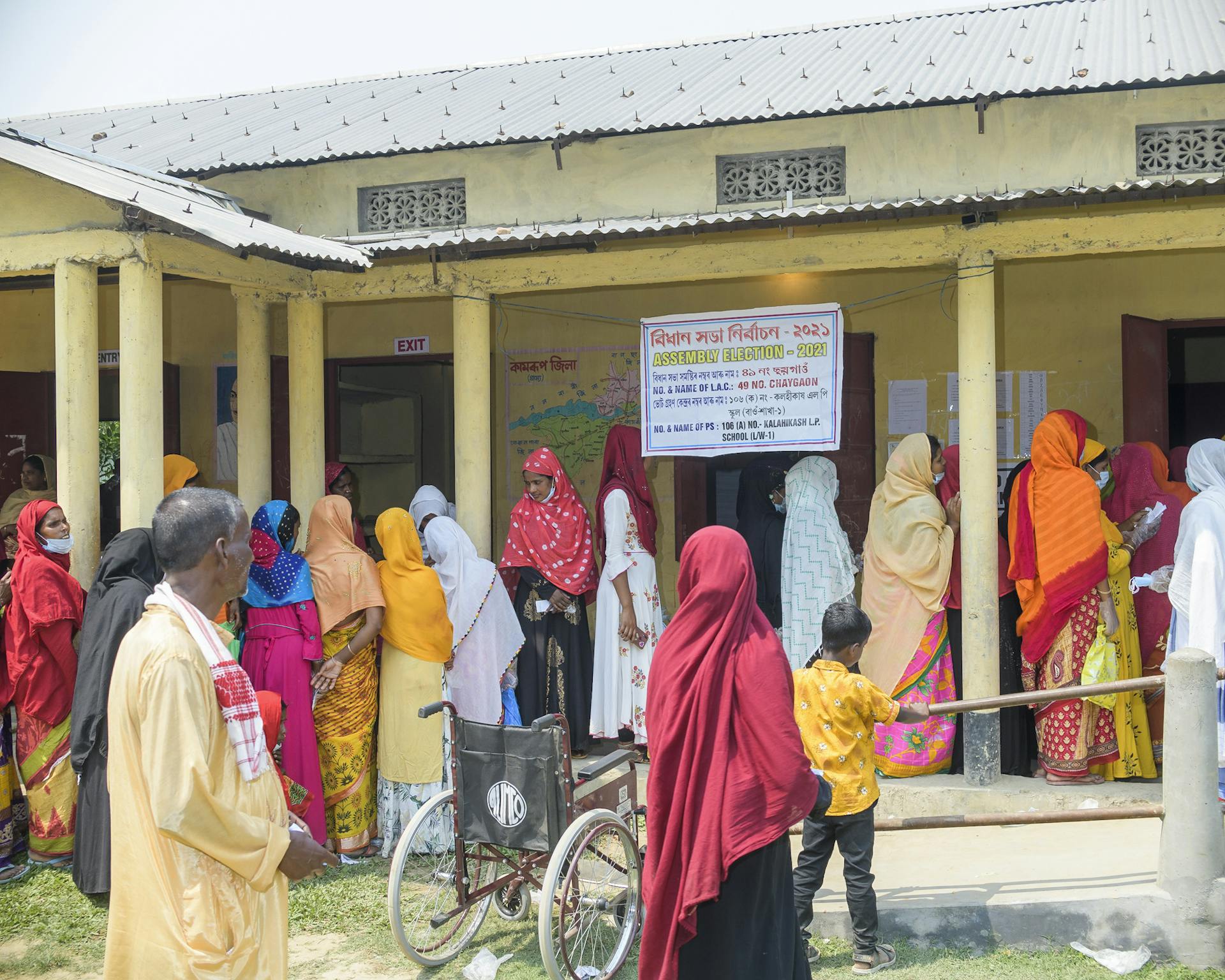 Women line up at the lower primary school in Kalahikash to vote in the assembly election, earlier this year. Picture credit: Prakash Bhuyan.