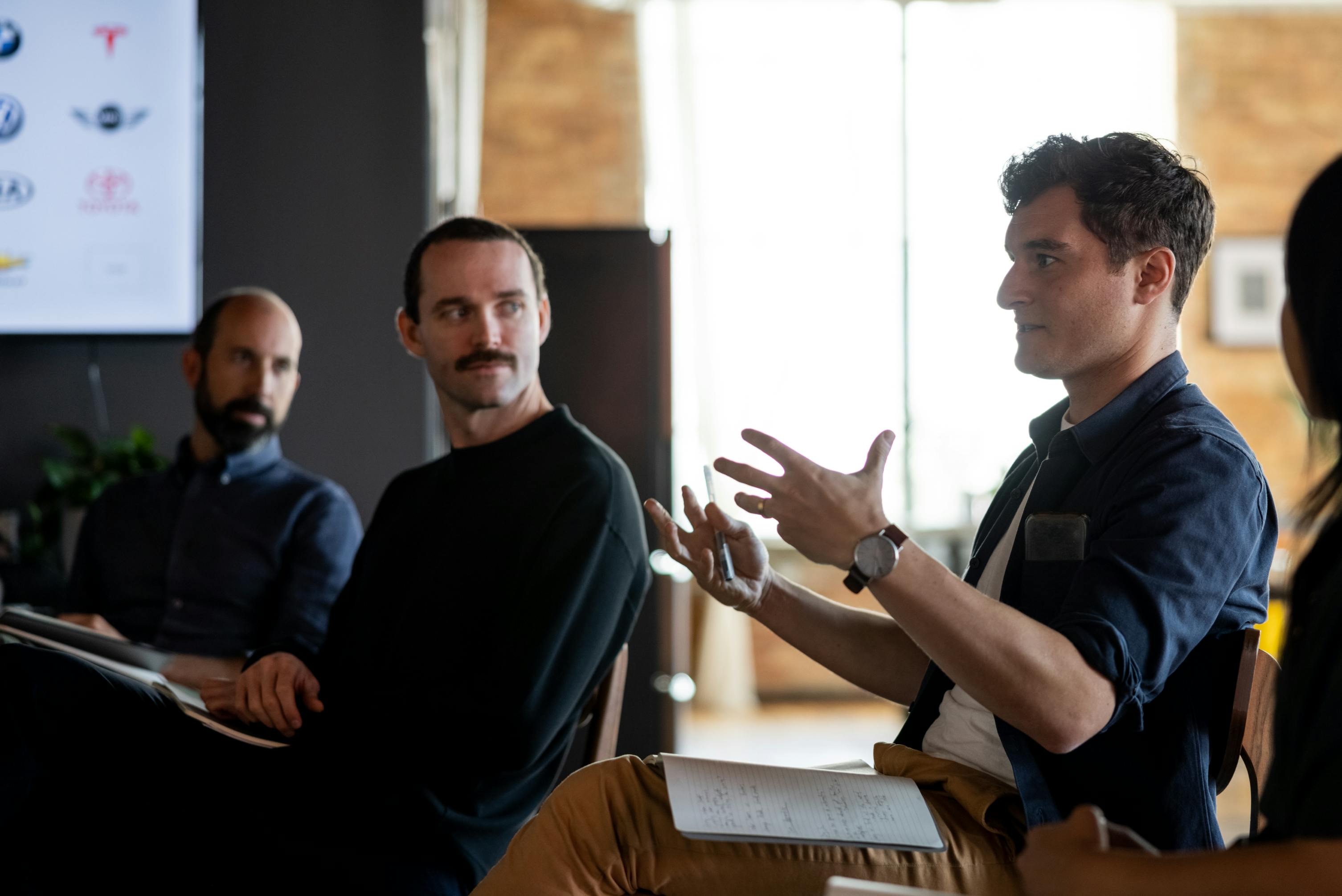 Two Figure employees participate in a group discussion.