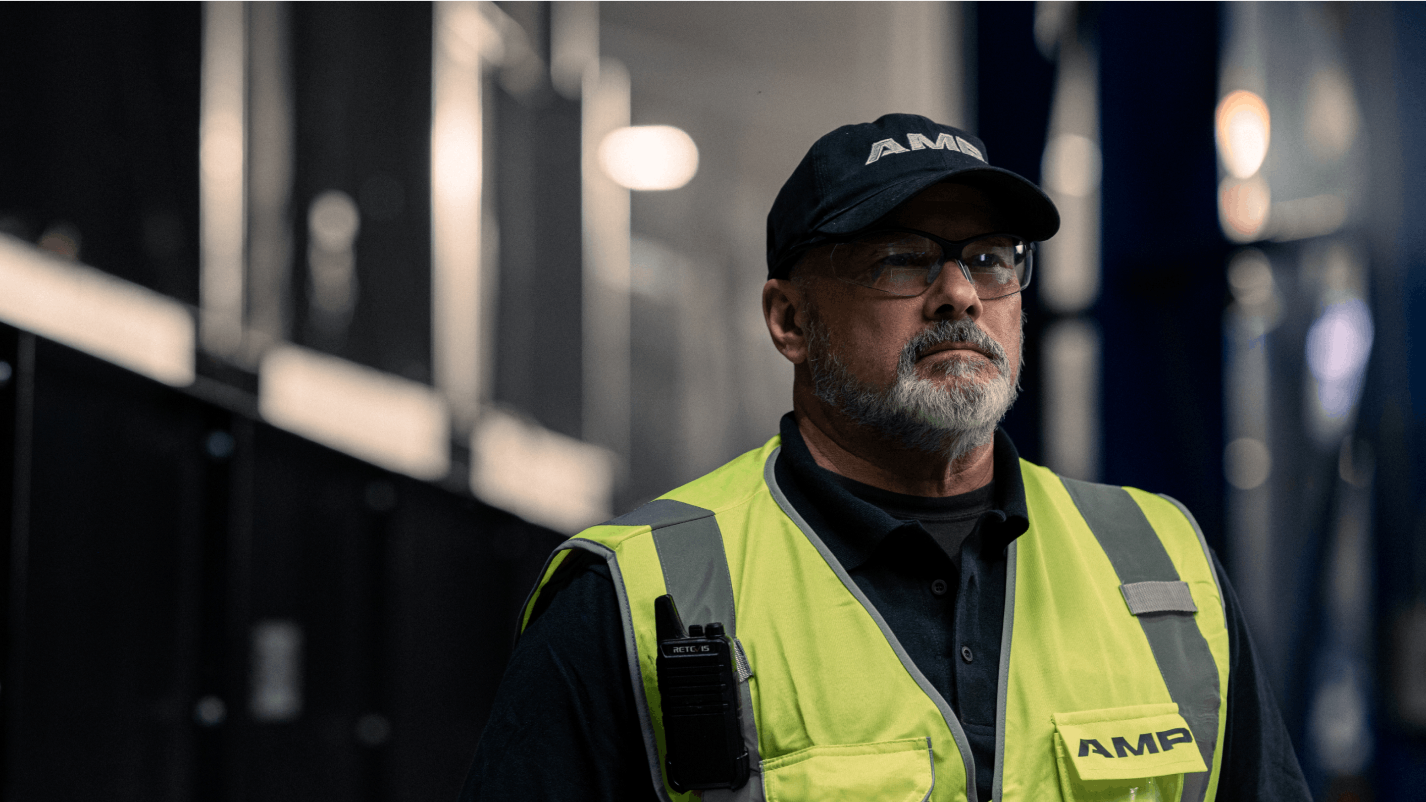 A portrait of a site manager wearing AMP gear inside of a waste facility.