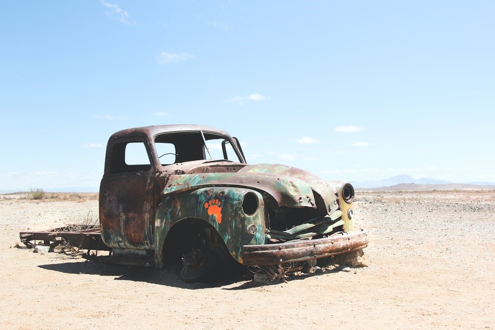 sanding a rusty car