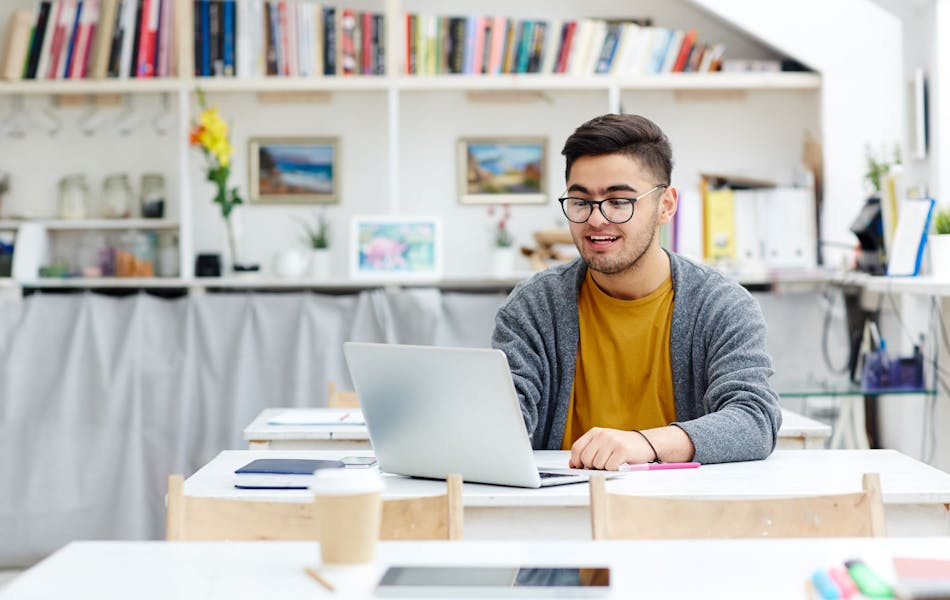 man on a computer, sat at a desk