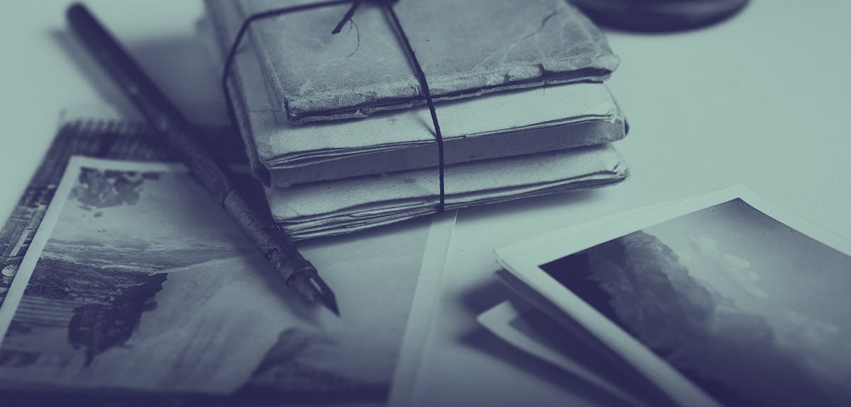 Old books, photographs and a pen