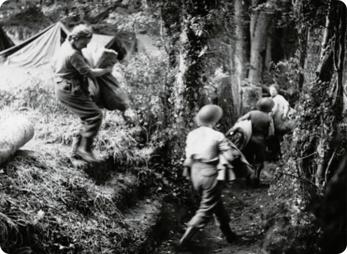 Military nurses from Queen Alexandra's Imperial Military Nursing Service, pictured setting up their beds in a trench, 1944.