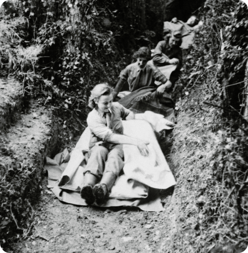 Military nurses from Queen Alexandra's Imperial Military Nursing Service, pictured setting up their beds in a trench, 1944.