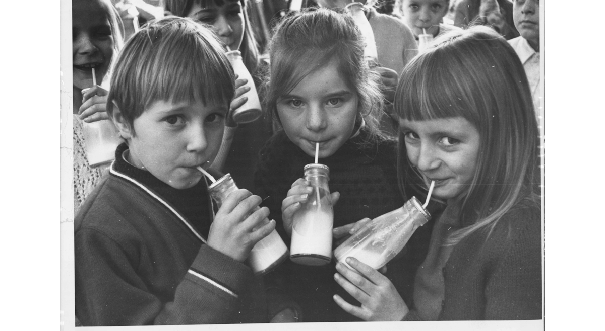 Old school photo of children drinking milk