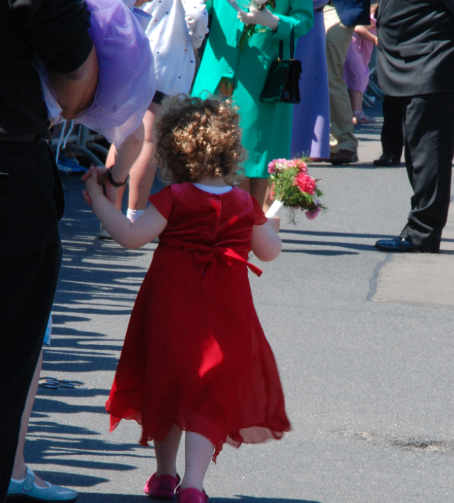 Mo as a young girl, on her way to present flowers to the Queen.