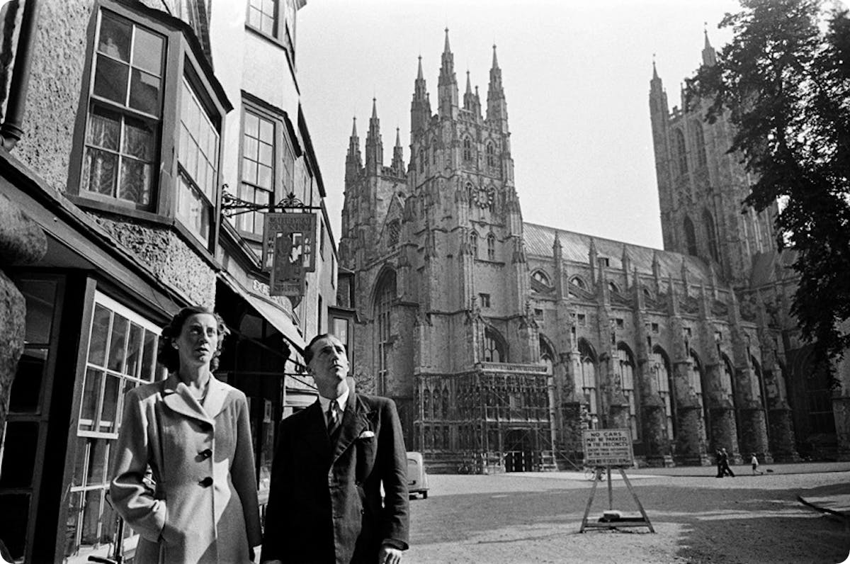 An old photo of people in front of Canterbury Cathedral