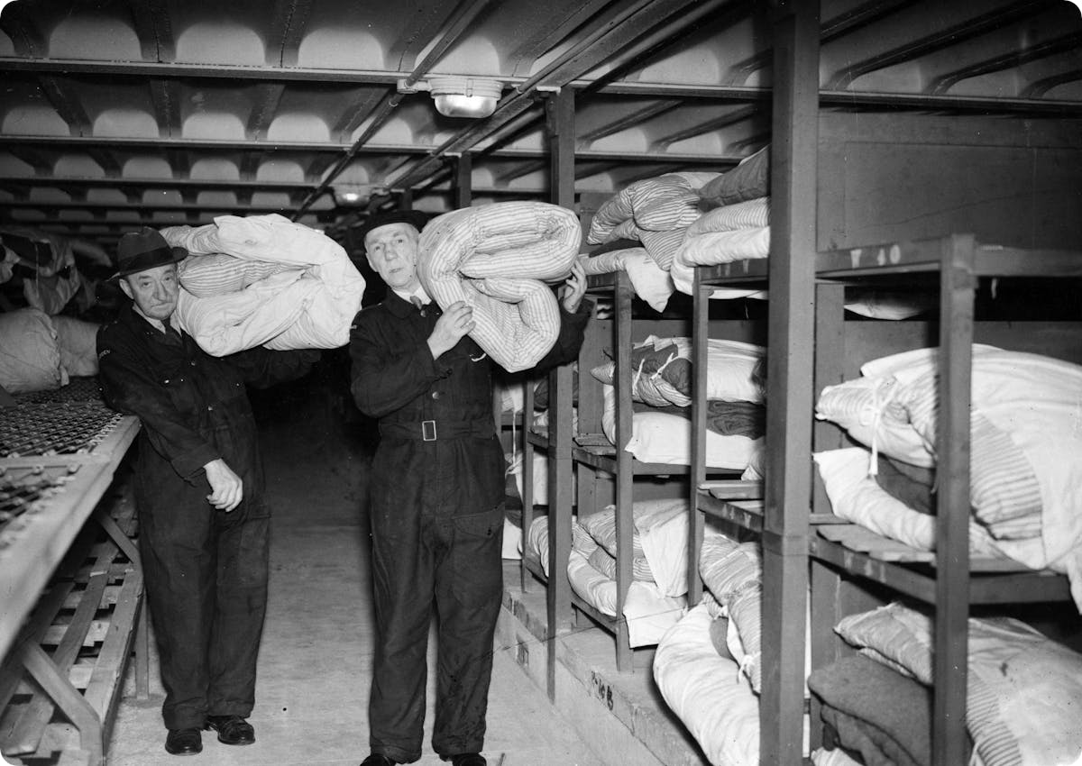 Air raid wardens providing bedding to a newly-opened shelter in Stockwell, London, 1942.