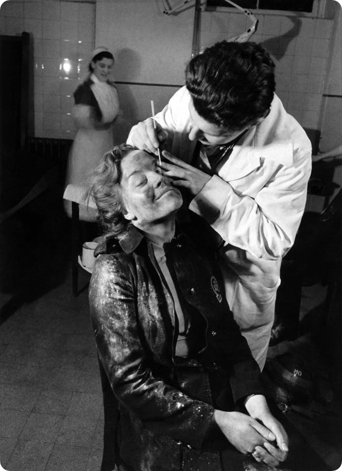 A member of the Auxiliary Fire Service receives treatment for an eye injury