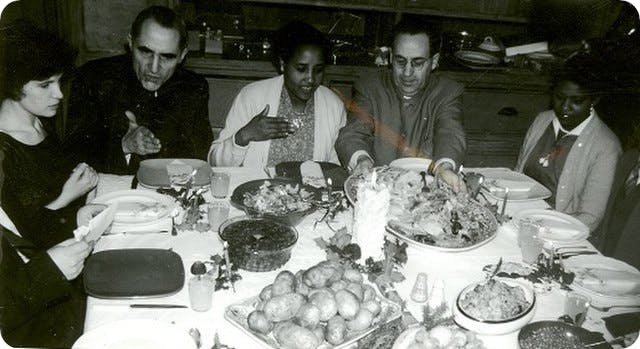 A group of people having Chrismas dinner in London in 1958