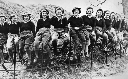 A group of Women's Land Army land girls posing for a photograph