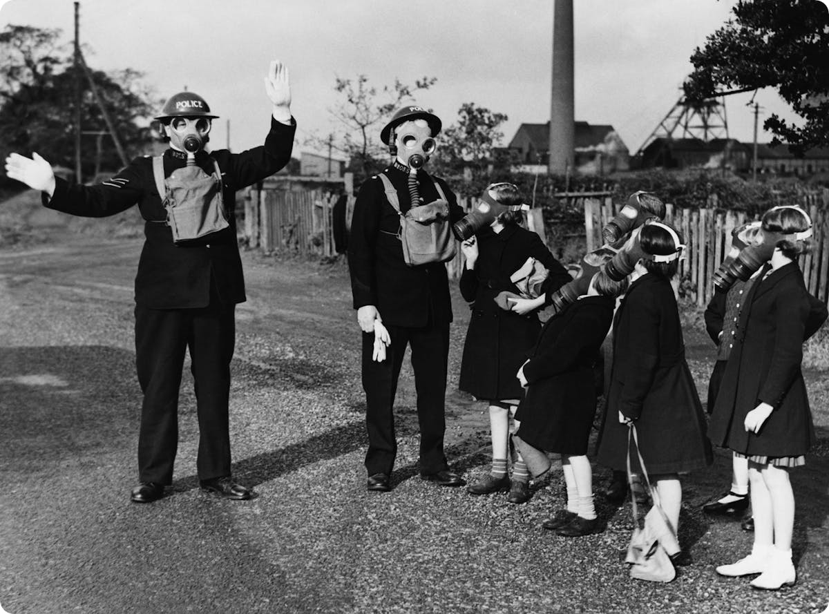 ARP wardens demonstrating gas masks to children during World War 2
