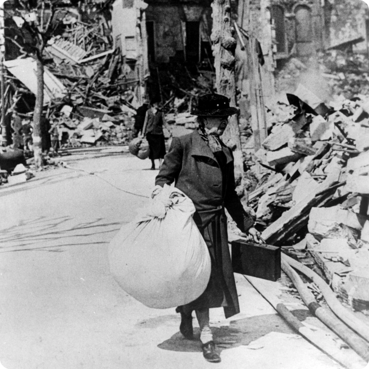A woman carries her remaining possessions through the rubble in Bristol.