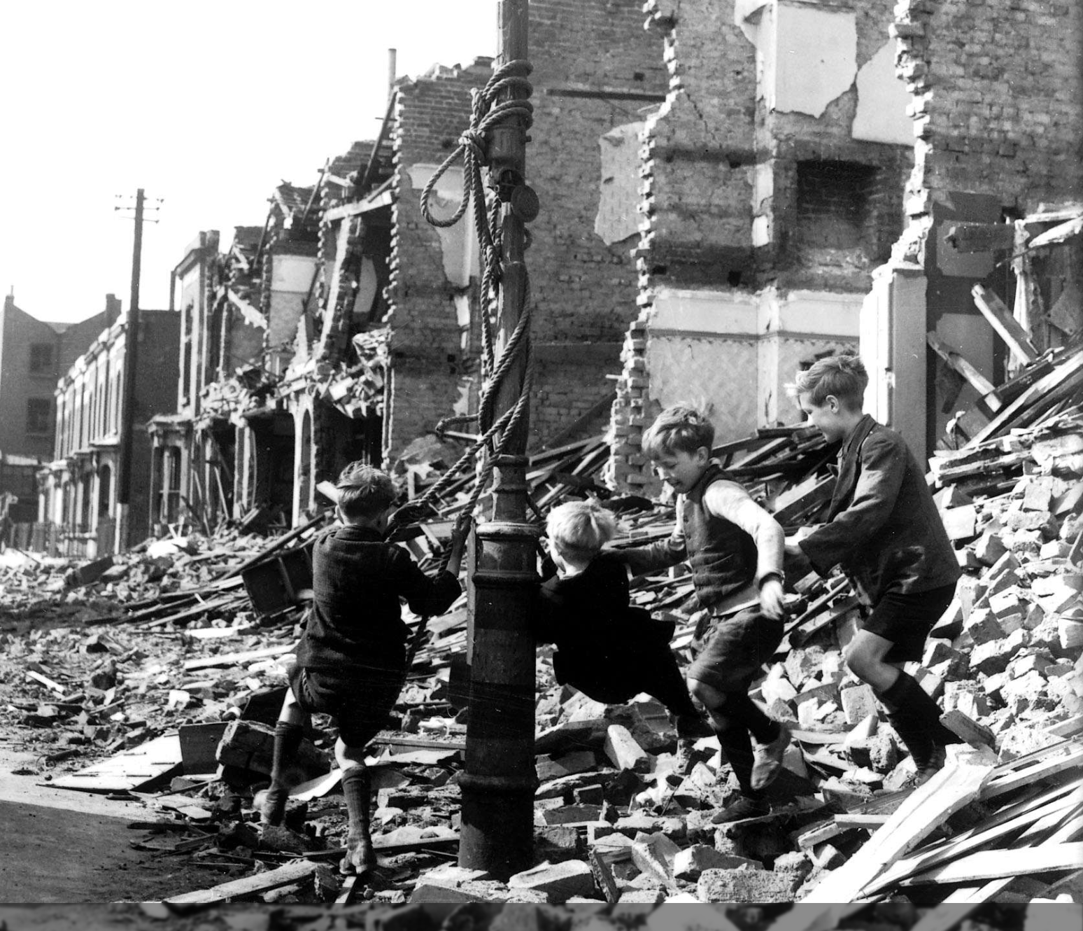 Children playing on a makeshift swing, 1940. 