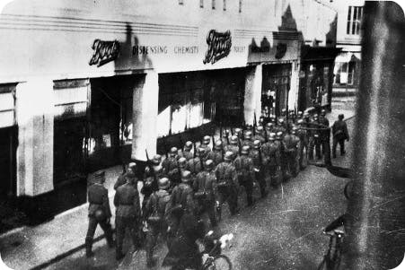 German soldiers marching past a Boots pharmacy in the Channel Islands