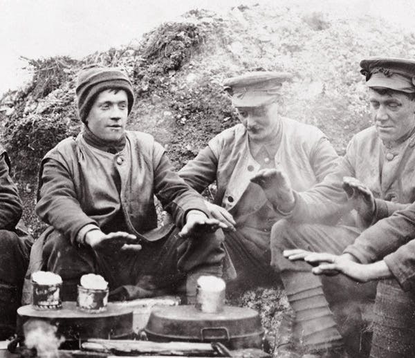First World War soldiers gathered around a camp fire.