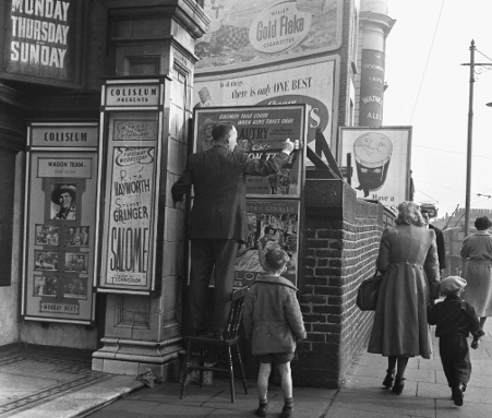 adverts being put up at a london cinema