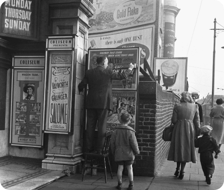 adverts being put up at a london cinema
