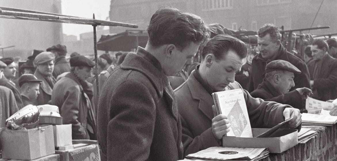 Men browsing records at a stall in the 1950s