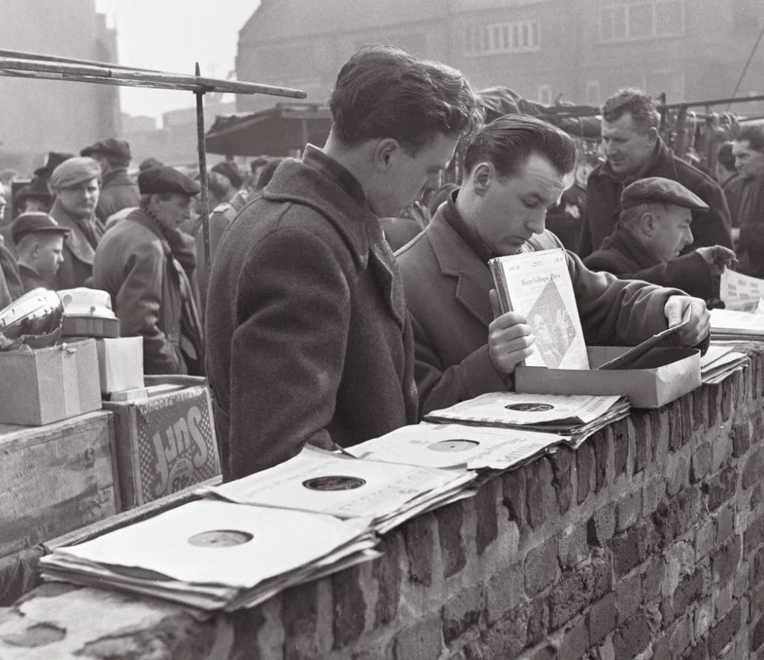 Men browsing records at a stall in the 1950s