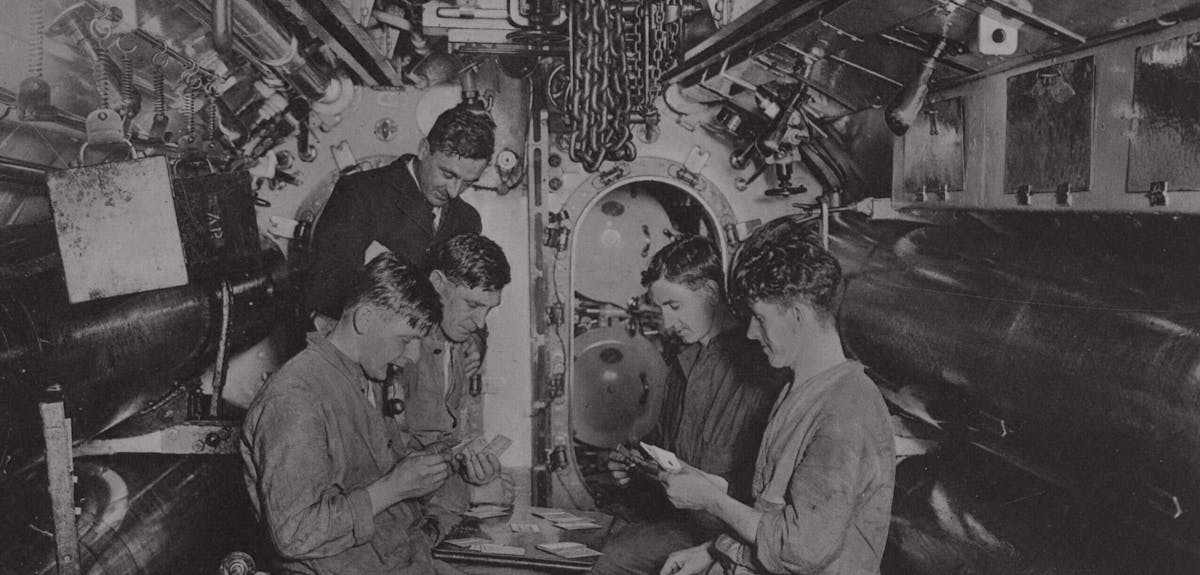 Ratings and an officer playing cards aboard a Royal Navy submarine