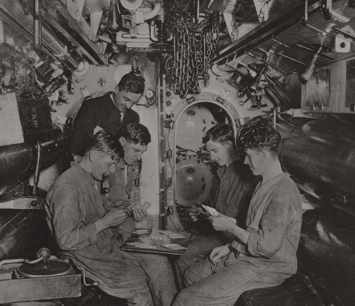 Ratings and an officer playing cards aboard a Royal Navy submarine