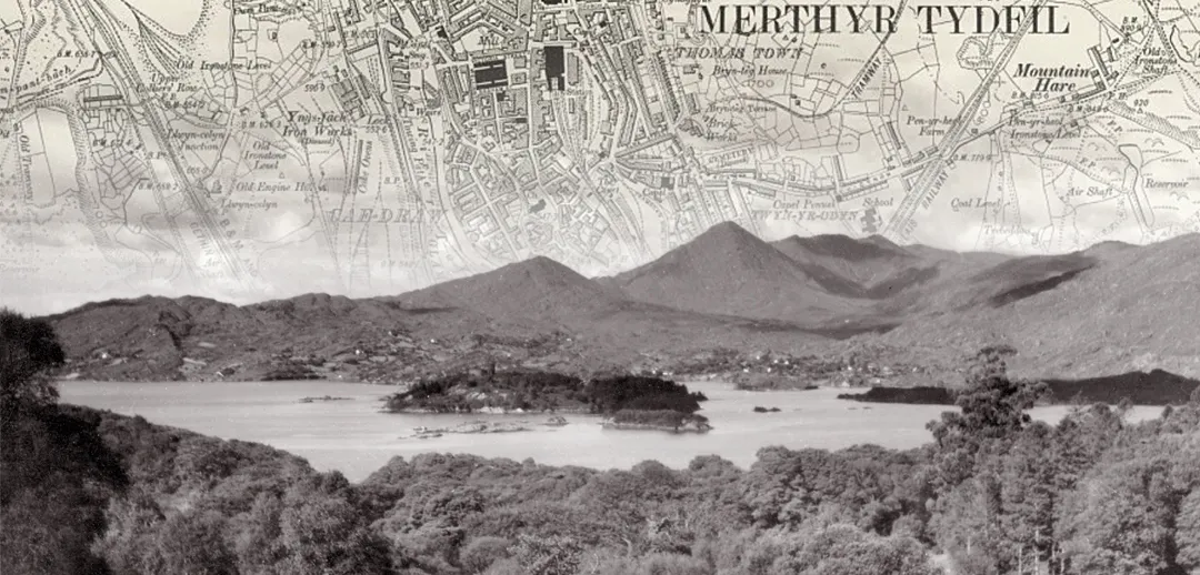 Black and white photo of a lake, with an old map of Merthyr Tyfil fading into the sky