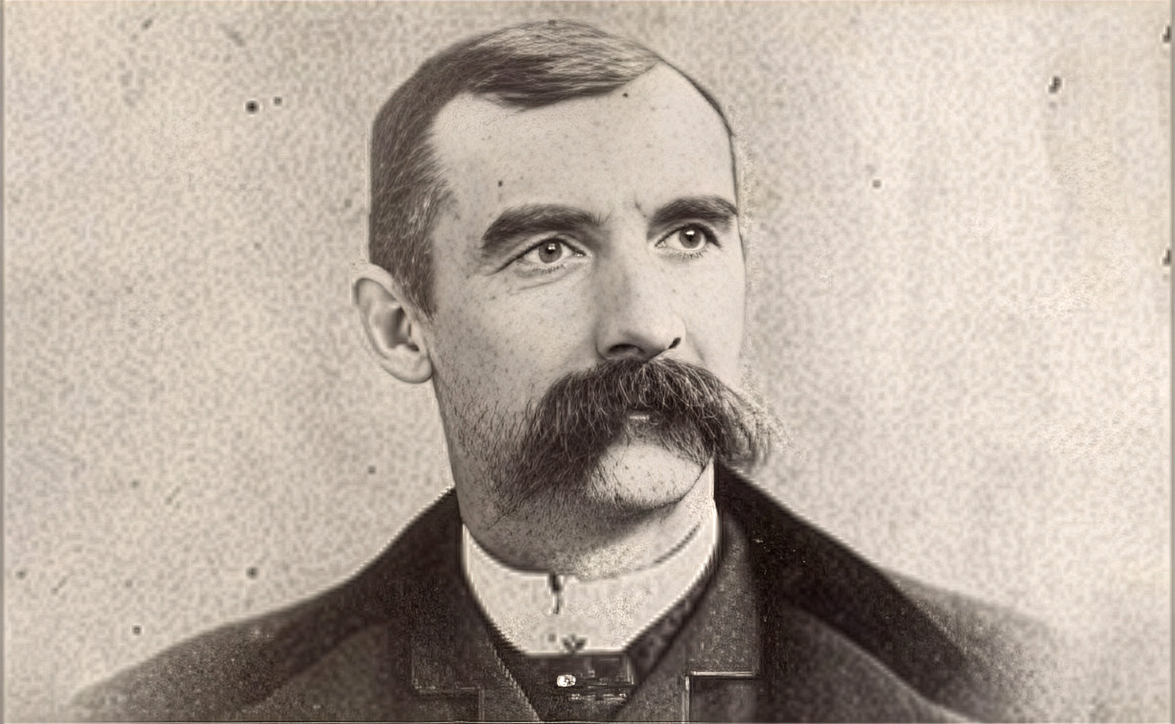 Black and white photo of a man with a mustache