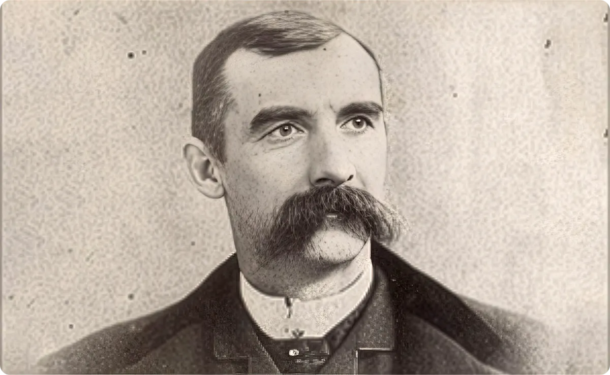 Black and white photo of a man with a mustache