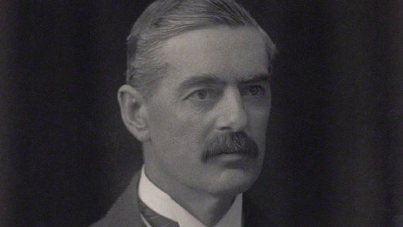 A black and white photograph of Neville Chamberlain. 