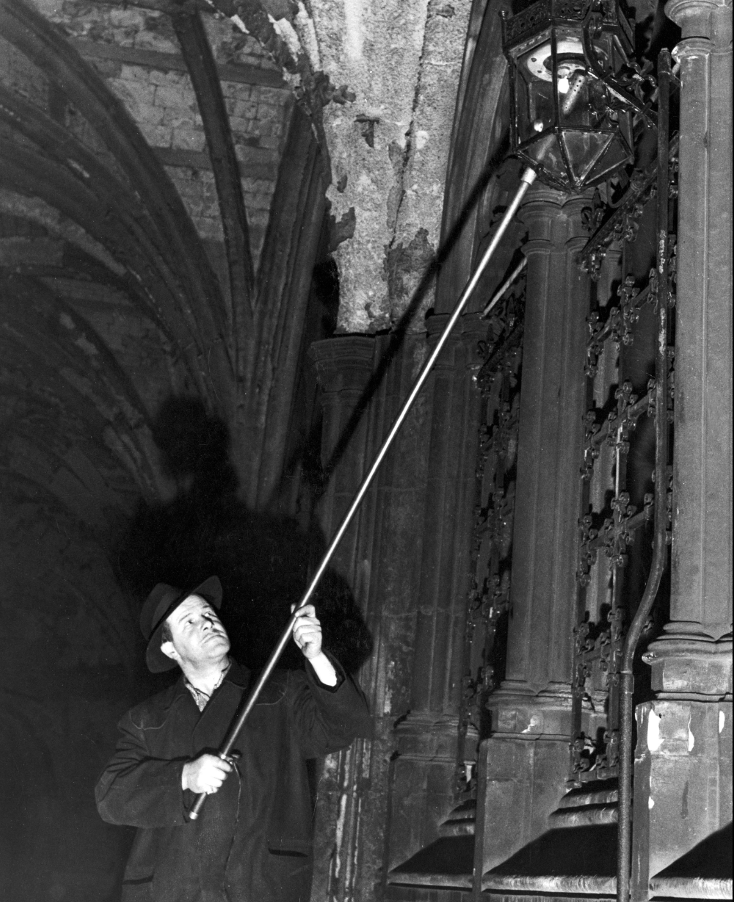 lamplighter lighting a gas lamp