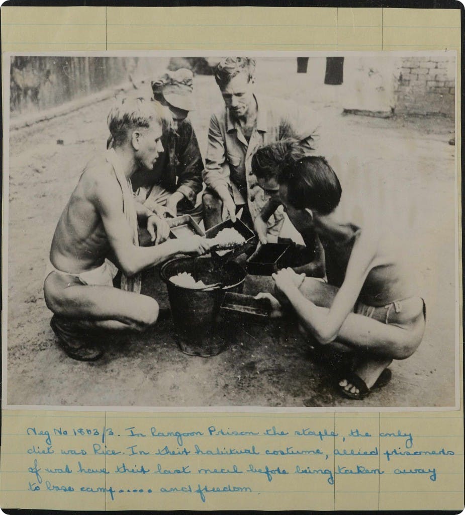 Impoverished prisoners sharing food at a Japanese PoW camp during WW2