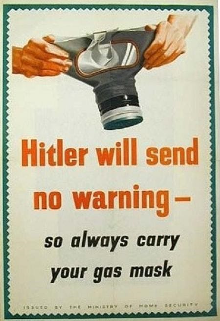 WW2 poster from the ministry of home security advising people to have gas masks on hand. There is a drawing of two hands holding a gas mask open, ready to be put on. Underneath, the text reads: "Hitler will send no warning, so always carry your gas mask".