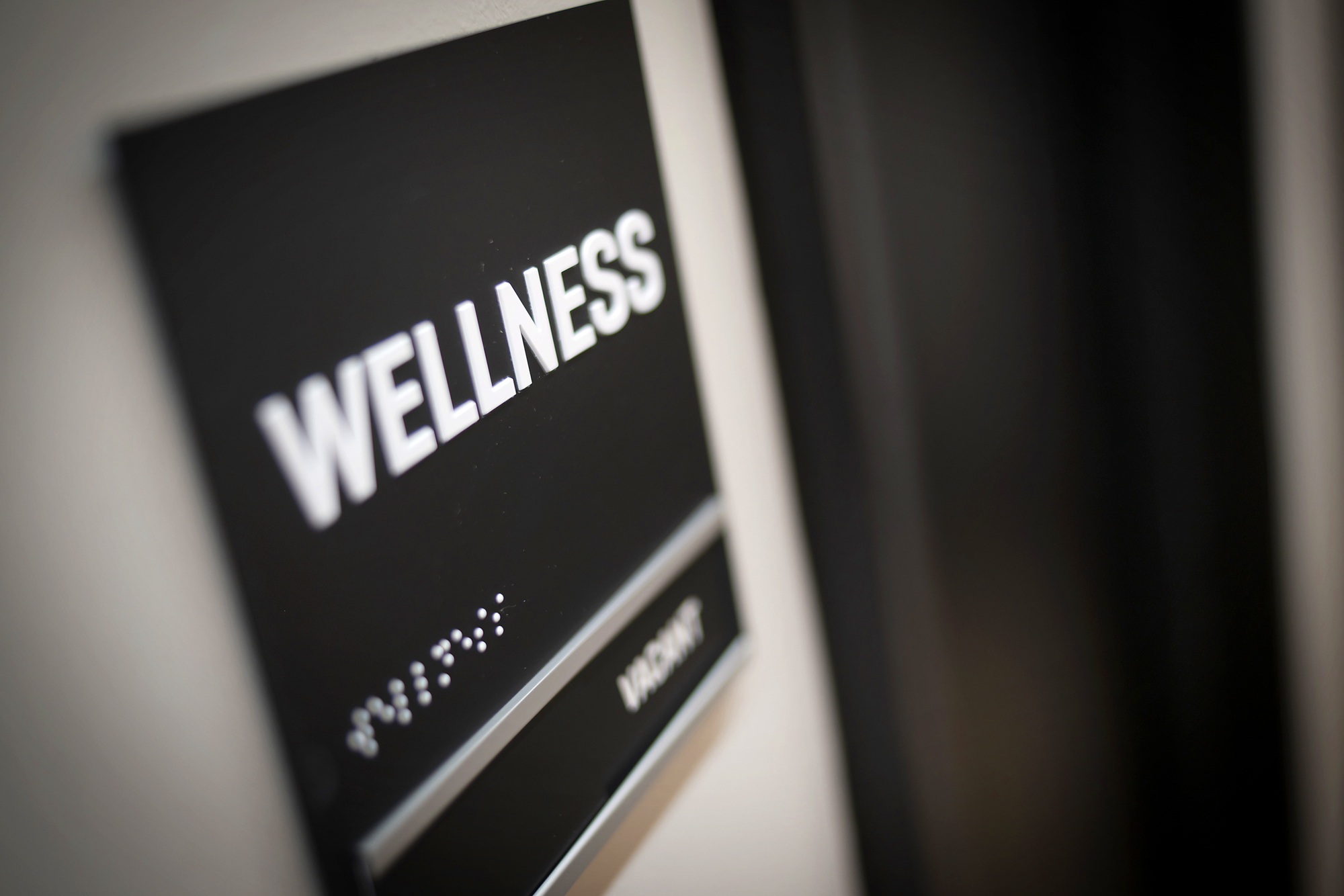An office wall sign which reads wellness