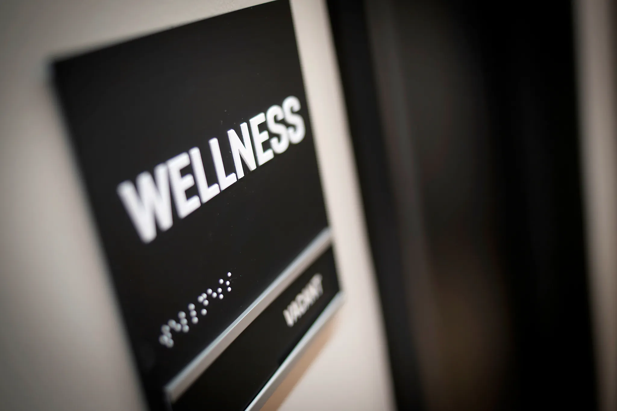 An office wall sign which reads wellness