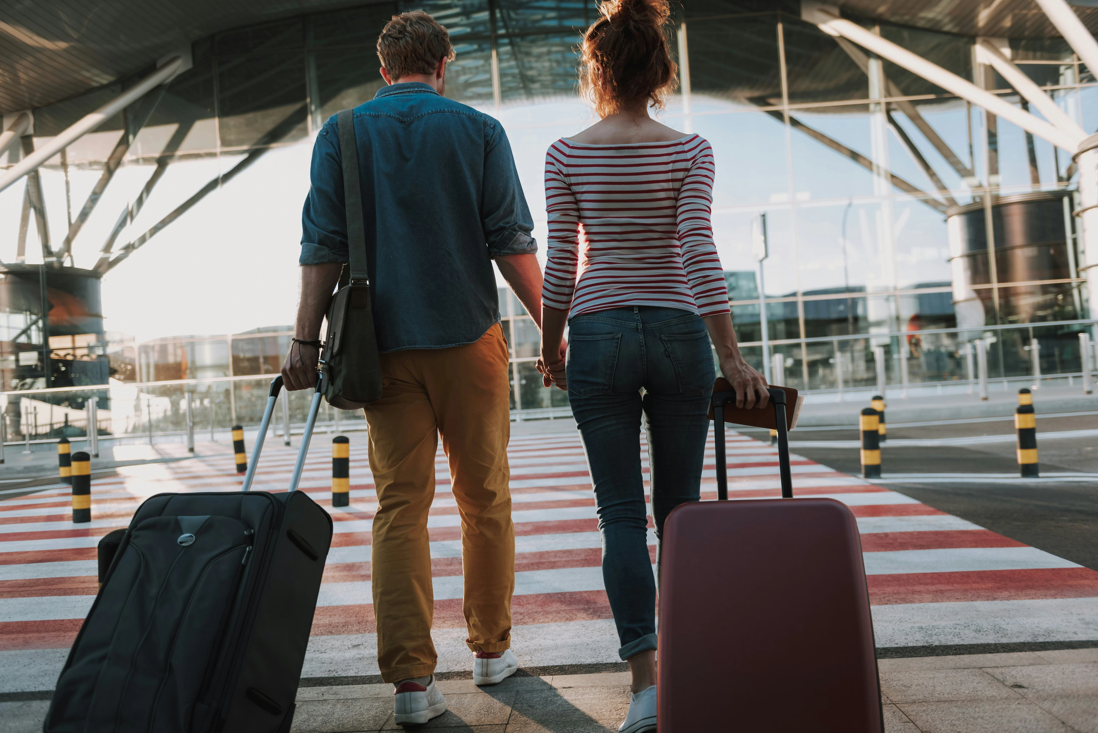 a photo of two people with suitcases