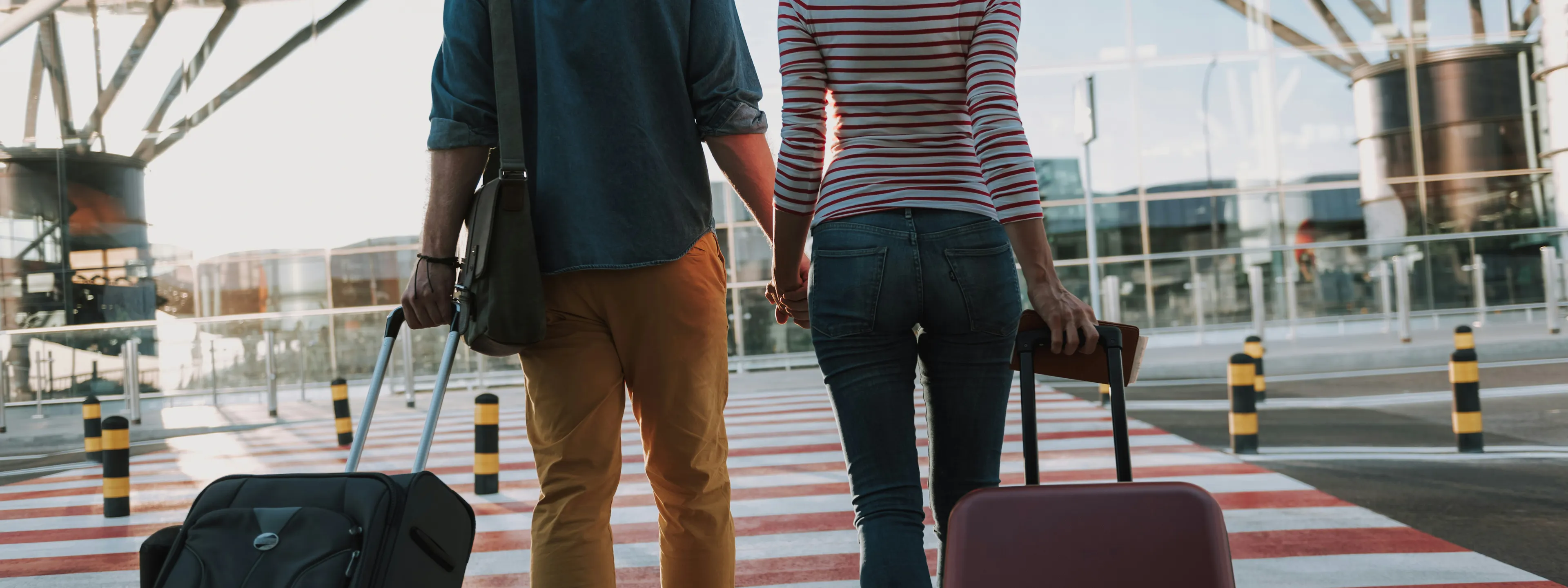 a photo of two people with suitcases